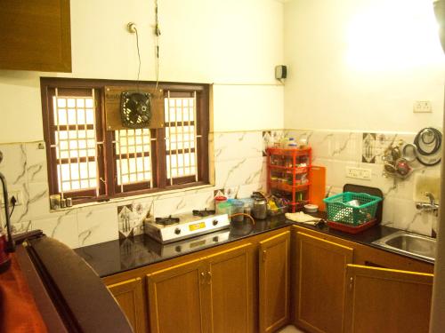 a kitchen with a sink and a counter top at Skylarc Inn in Ooty