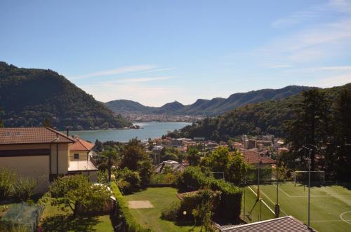 a view of a town with a lake and mountains at Albergo Della Torre in Cernobbio