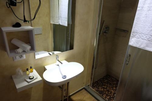 a bathroom with a sink and a shower at La Rocca Guest House & Spa in Montefalco