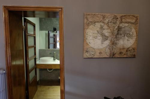 a bathroom with a map on the wall next to a mirror at La Rocca Guest House & Spa in Montefalco