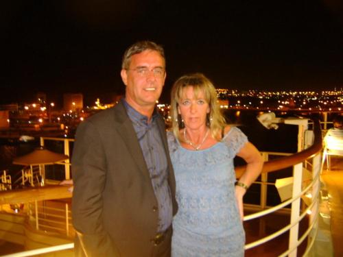 a man and woman standing on a boat at night at Hotel Laurin in Lagundo