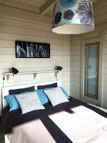 a bedroom with a bed with blue and white pillows at Casa San Martino in Atri