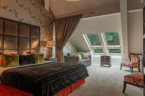 a bedroom with a large bed and a couch at Orsett Hall in Orsett