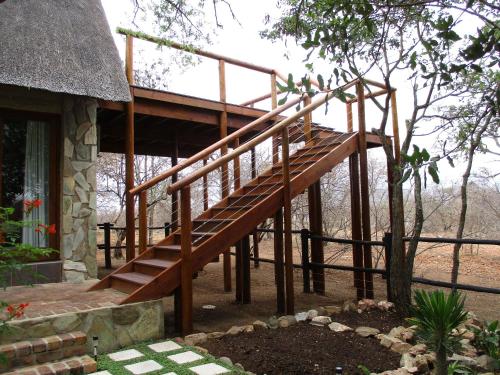 a wooden staircase on the side of a house at Woodpecker Lodge B&B in Hoedspruit