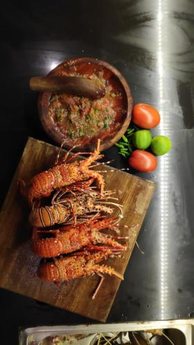 a wooden cutting board with some food on it at Kimo Resort Pulau Banyak Aceh Singkil in Alaban