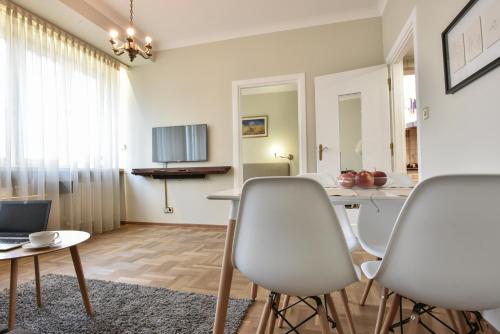 a living room with chairs and a table in it at Smulikowskiego 9 in Warsaw