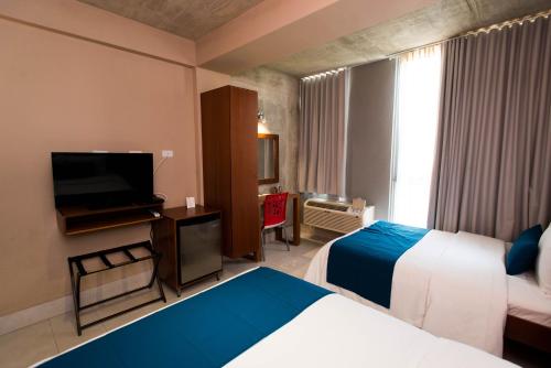 Postel nebo postele na pokoji v ubytování Dream Inn PR