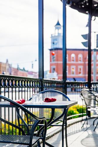 a table with red napkins on it on a balcony at Colgate Inn in Hamilton