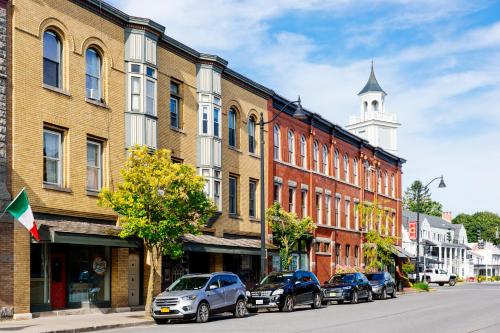 a city street with cars parked in front of buildings at Colgate Inn in Hamilton