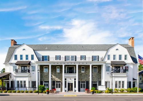 a large white house with an american flag at Colgate Inn in Hamilton