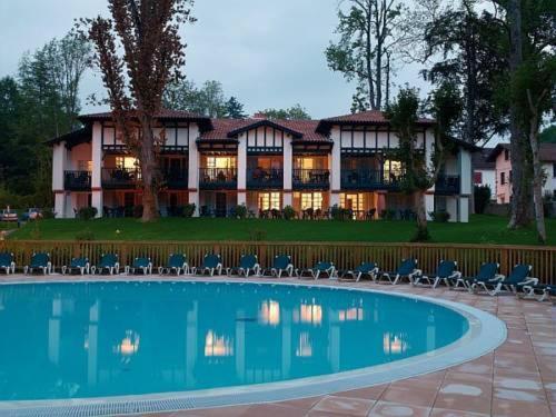 a large house with a pool in front of it at Parc Arradoy in Saint-Jean-Pied-de-Port