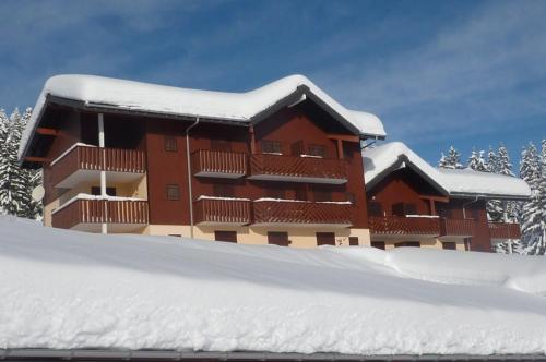 a building covered in snow with a pile of snow at MONT BLANC Soleil C19 in Manigod