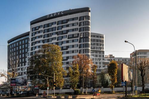 wysoki budynek z znakiem na boku w obiekcie CITY Aparts w Lwowie