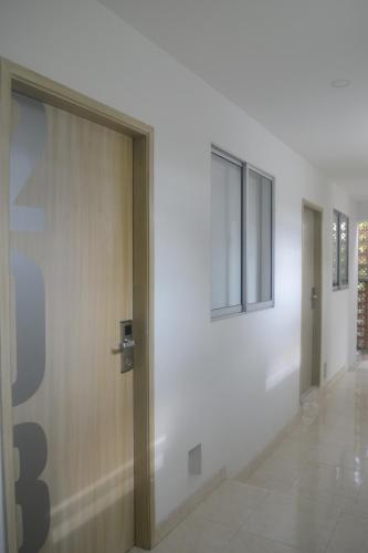 a hallway with a door and a window at Hotel Calarca Club in Montería
