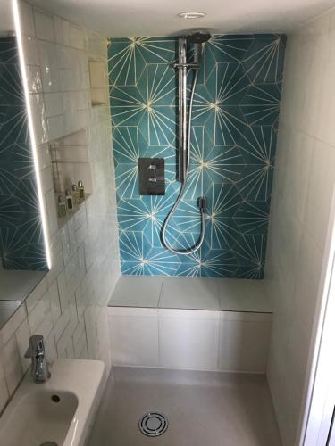 a bathroom with a shower and a sink at Fistral Hideaway in Newquay