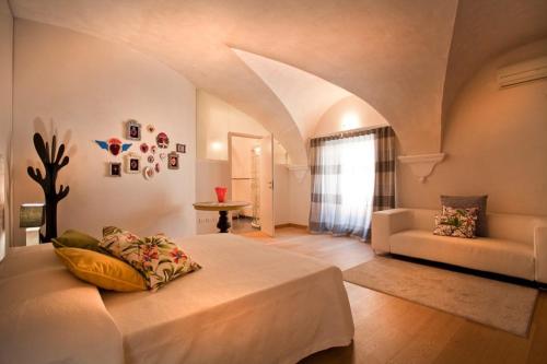 a bedroom with a bed and a couch in a room at Anfite Luxury Apartment Affresco San Silvestro in Verona
