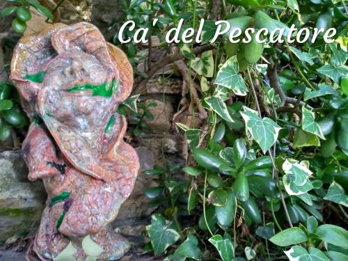 a statue of a woman standing next to a plant at ca del pescatore in Cervo