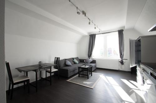 a living room with a couch and a table at BITO CAMPUS in Meisenheim