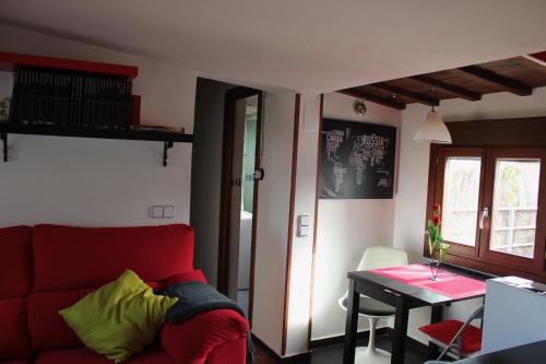 a living room with a red couch and a table at La Plata in Toledo