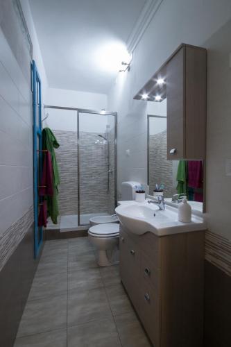 a bathroom with a sink and a toilet and a shower at B&B la Bitta in Cagliari