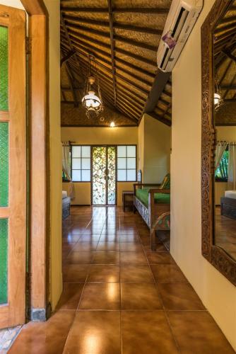 an open floor plan with a living room and a hallway at Hotel Pondok Sari Beach & SPA Resort in Pemuteran