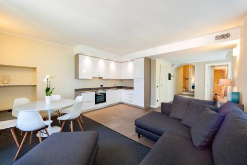 a living room with a couch and a table at Liszt Tower by KlabHouse in Bellagio