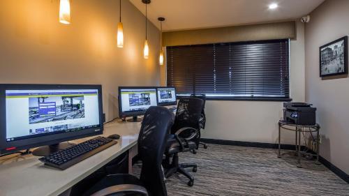 an office cubicle with two computer monitors on a desk at Best Western Seattle Airport Hotel in SeaTac