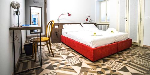 a bedroom with a bed and a table and a desk at Locanda Mimmo in Bergamo