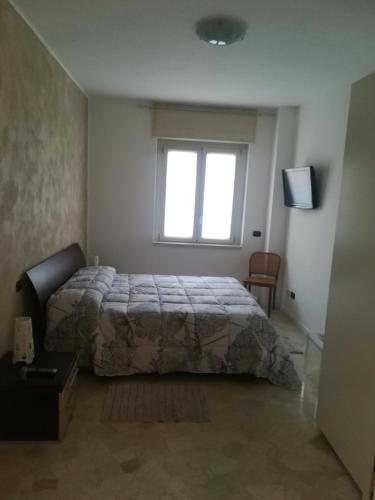 a bedroom with a bed and a window and a television at Staurenghi34apartmenT in Varese