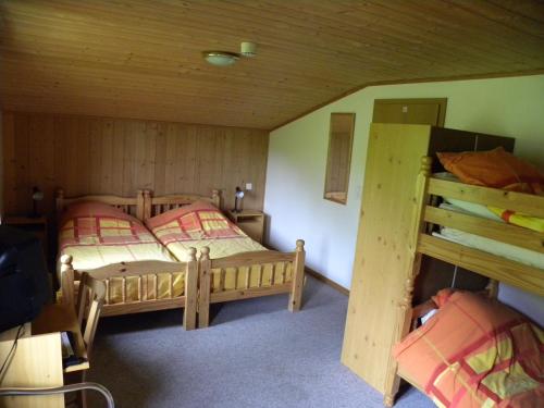 a bedroom with two beds and a bunk bed at Hotel Restaurant Walliser Sonne in Reckingen - Gluringen