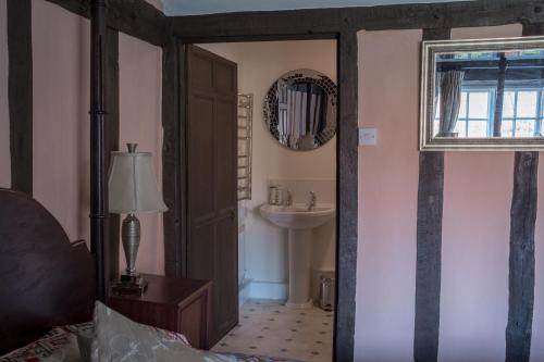 a bathroom with a sink and a mirror at St Mary’s Bed & Breakfast in Bury Saint Edmunds