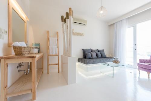 a living room with a couch and a table at Eva Mare Hotel & Suites - Adults only in Agia Pelagia