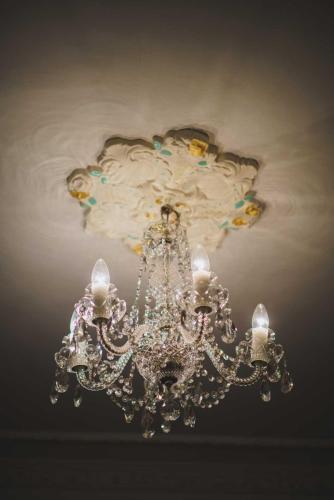 a silver chandelier hanging from a ceiling at Ramsukh Resorts and Spa in Mahabaleshwar