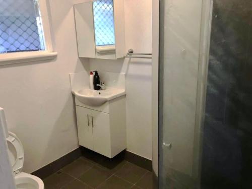 a small bathroom with a sink and a toilet at Maddington House Unit C in Perth