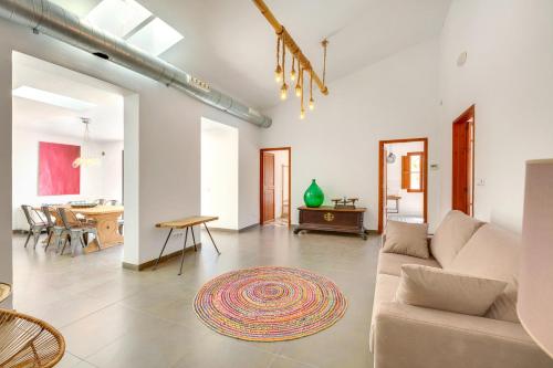 a living room with a couch and a table at Villa Palma, Establiments in Palma de Mallorca