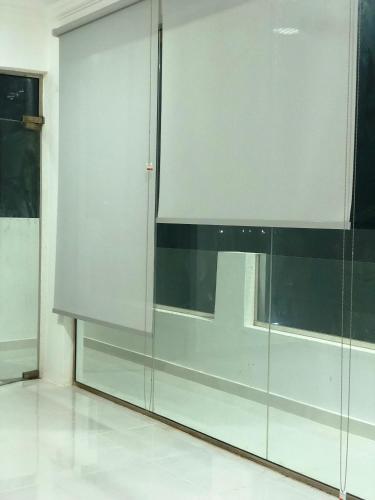 a sliding glass door in a room with a window at Home X4 in Al Wāşil