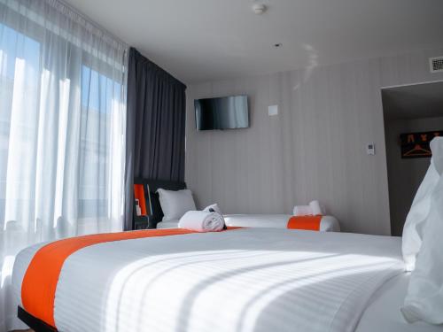 a hotel room with two beds and a window at easyHotel Lisbon in Lisbon