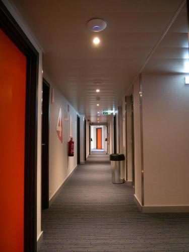 a hallway of an office building with a long corridor at easyHotel Lisbon in Lisbon
