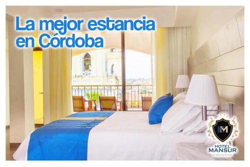 a hotel room with a bed and a balcony at Hotel Mansur Business & Leisure in Córdoba