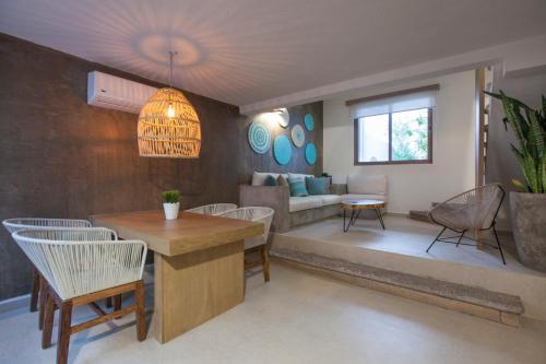 a living room with a table and chairs and a couch at Casa al Mar in La Paz