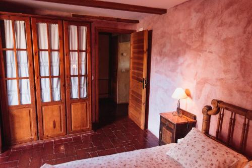 a bedroom with a bed and a lamp on a table at Mas Teixidor in Crespiá