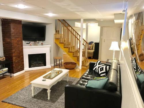 a living room with a couch and a coffee table at ~*Pet Friendly 30min to Downtown*~ THE BOSTONIAN in Boston
