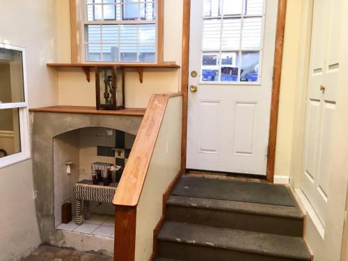 a stairway with a white door and a fireplace at ~*Pet Friendly 30min to Downtown*~ THE BOSTONIAN in Boston