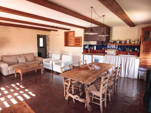 a living room with a wooden table and a couch at Mas Teixidor in Crespiá
