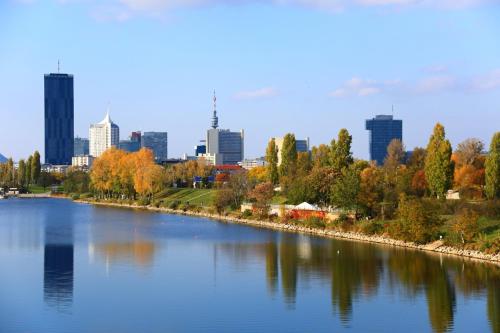 a view of a river with a city in the background at Bungalow at Lake Alte Donau in Vienna