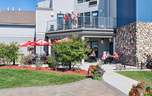 a group of people sitting on the balcony of a house at Park Point Marina Inn in Duluth