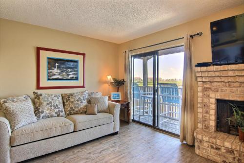 a living room with a couch and a fireplace at Seascape Villas in Padre Island