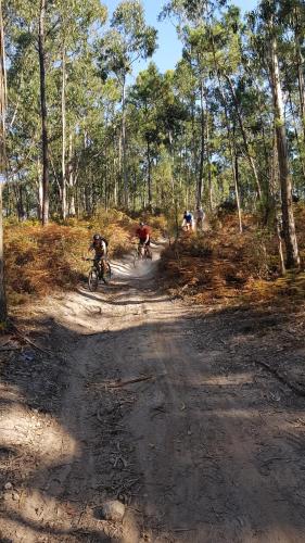 a group of people riding dirt bikes down a dirt road at InnEsposende Sports Hostel in Esposende
