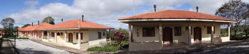 an old building with a red roof on a street at Hotel Fazenda Itáytyba in Tibagi