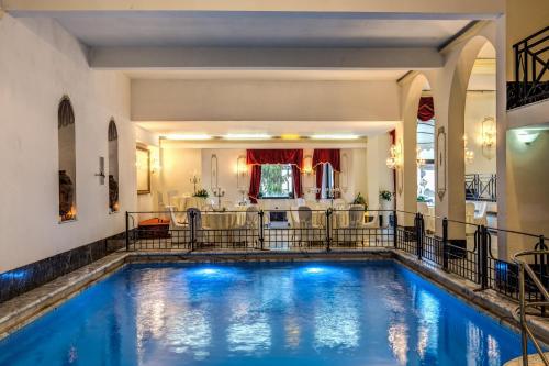 an indoor swimming pool in a home with a house at Hotel Castel Vecchio in Castel Gandolfo